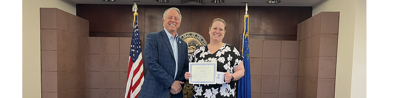 Governor Lombardo giving Nevada Film Office Las Vegas Employee Kim Spurgeon her 'Get Sh*t Done' Award on Nevada State Employee Appreciation Day