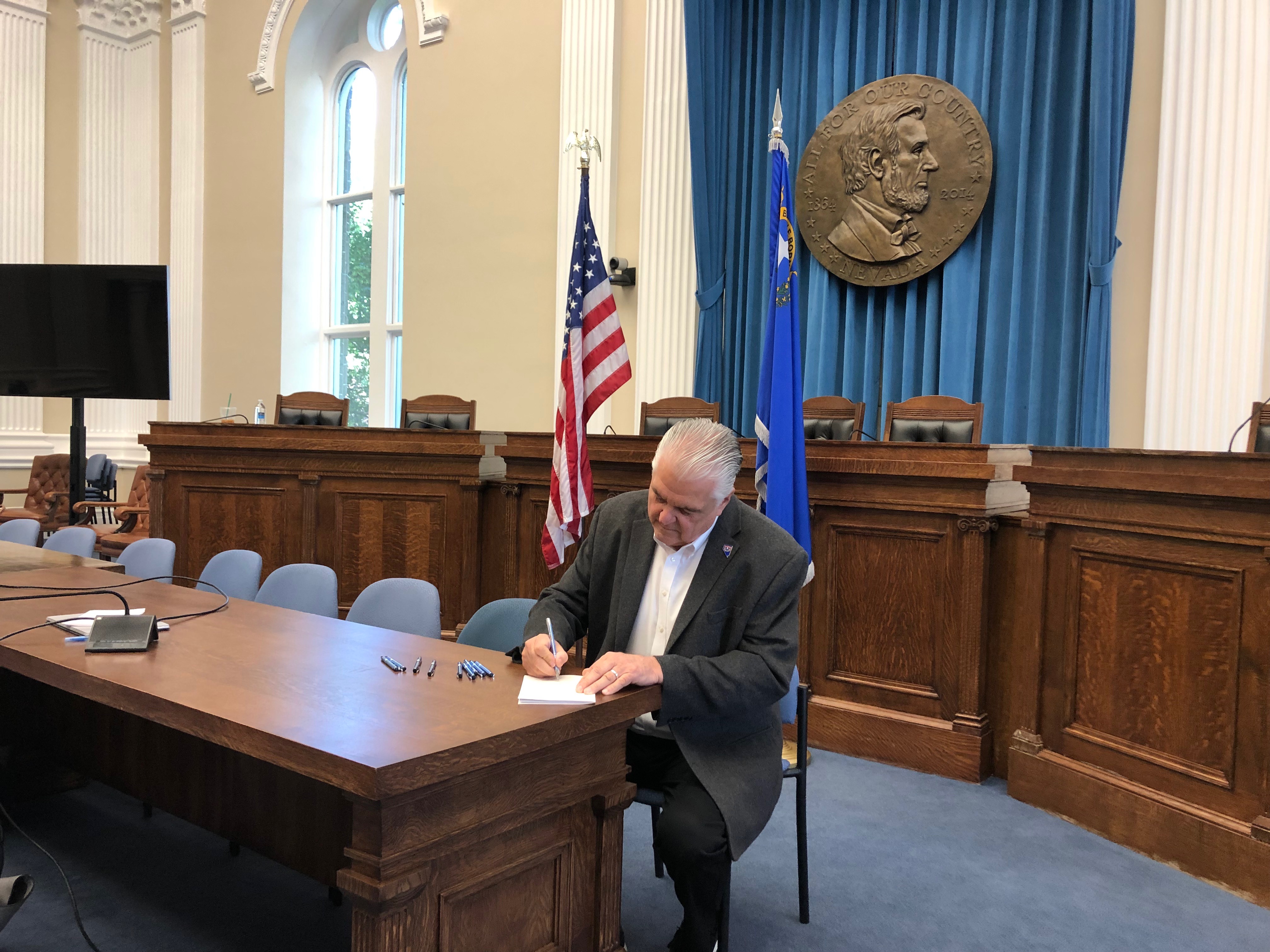 Governor Sisolak signing Senate Bill 544 on June 7, 2019