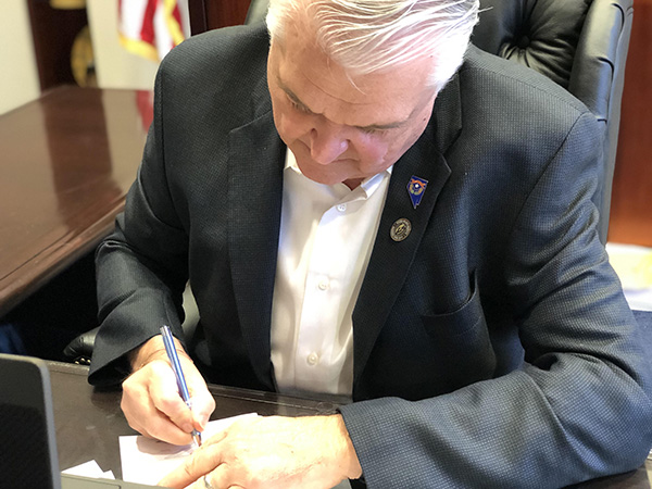 Close Up of Governor Sisolak Signing SB4